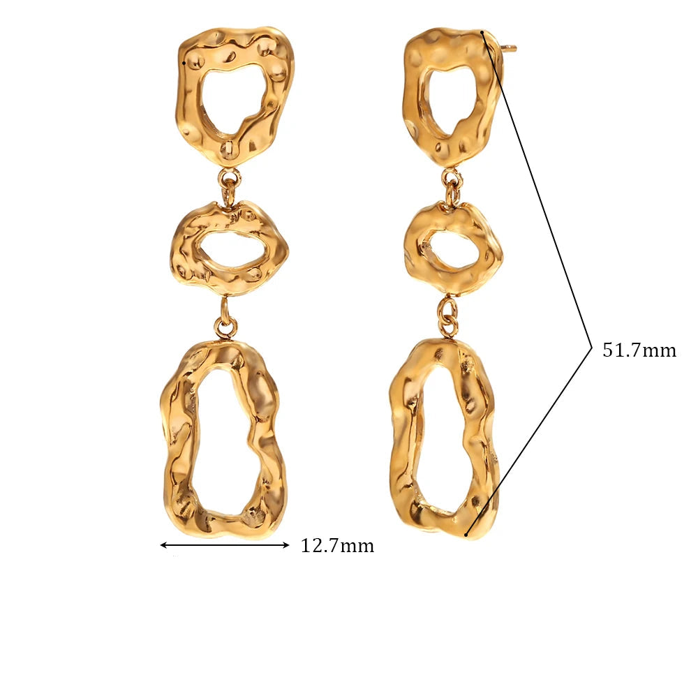 Gold earrings with measurements and material details on a white background