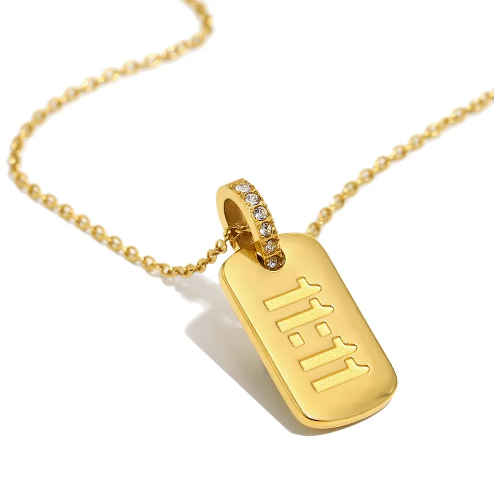 Gold necklace with a tag pendant on a white background, featuring the brand 'MAMACITASLAY'.