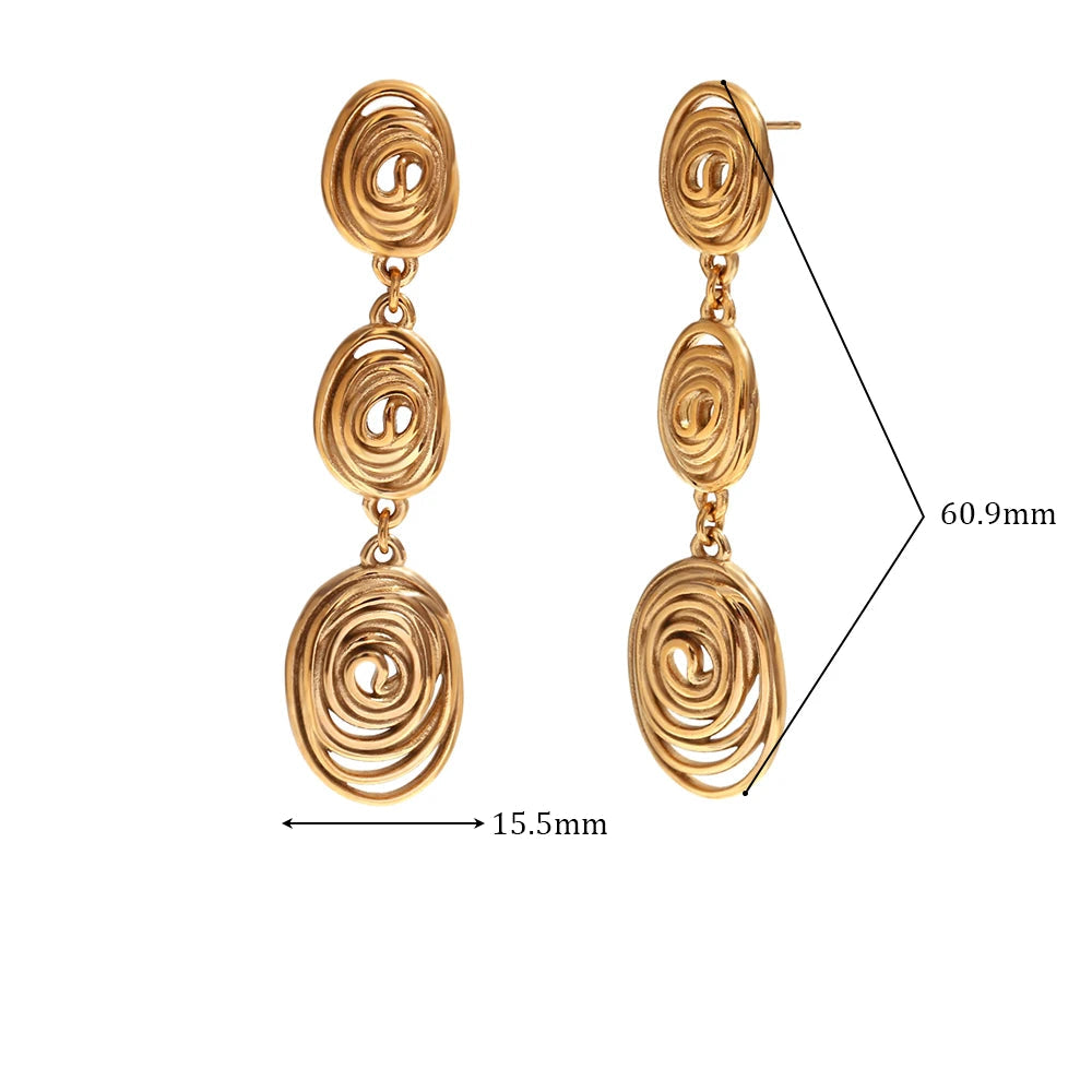 Pair of gold spiral earrings with measurements and material details on a white background